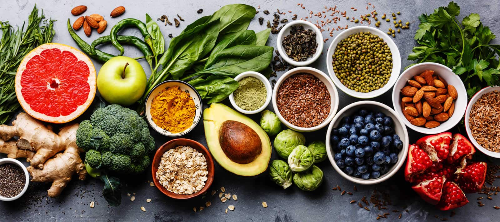 Colourful healthy food selection: fruit, vegetables, seeds, cereals, leaf vegetables
